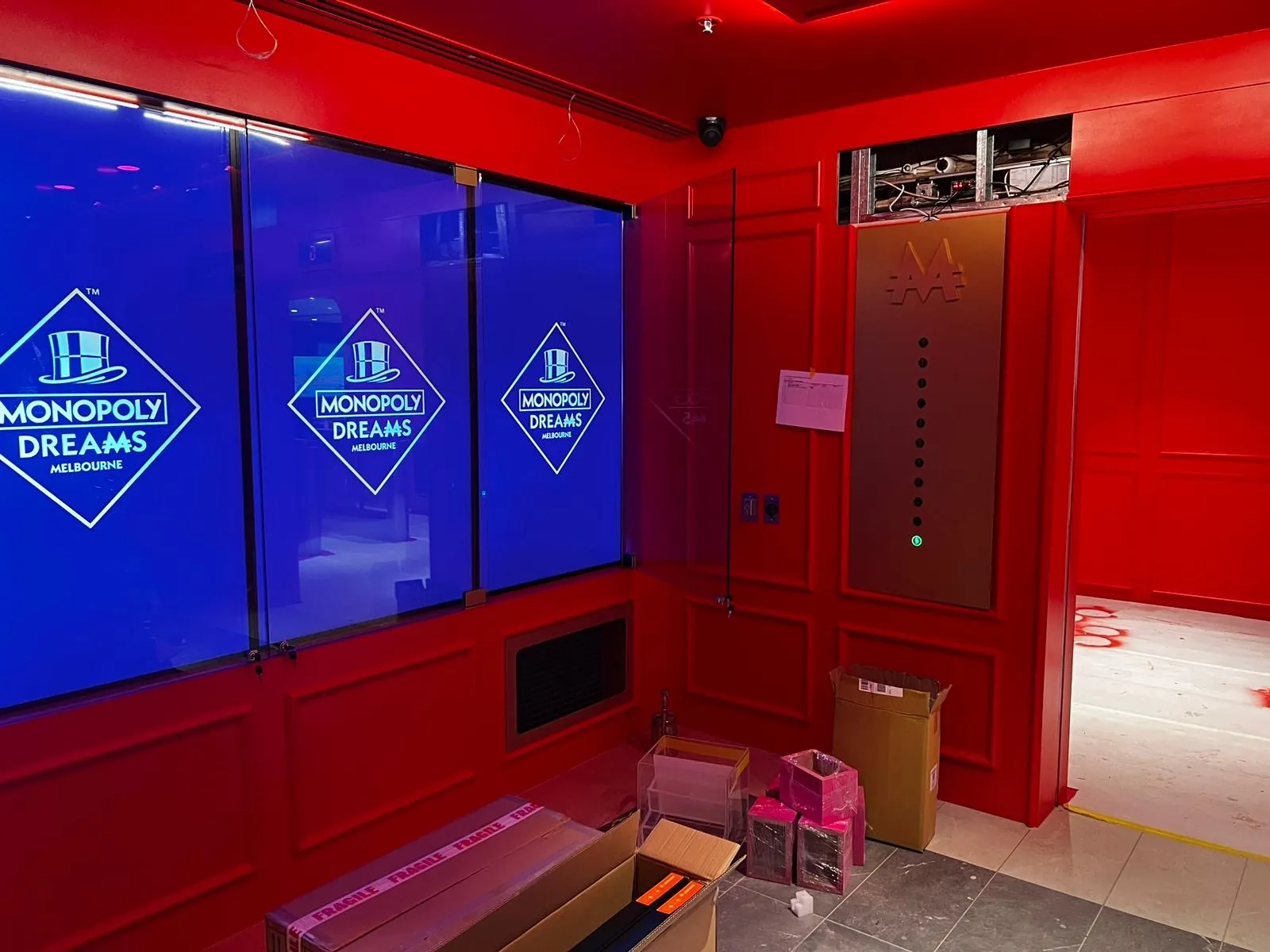 Red panelled walls and framed glazing inside the Monopoly Dreams Melbourne fit-out
